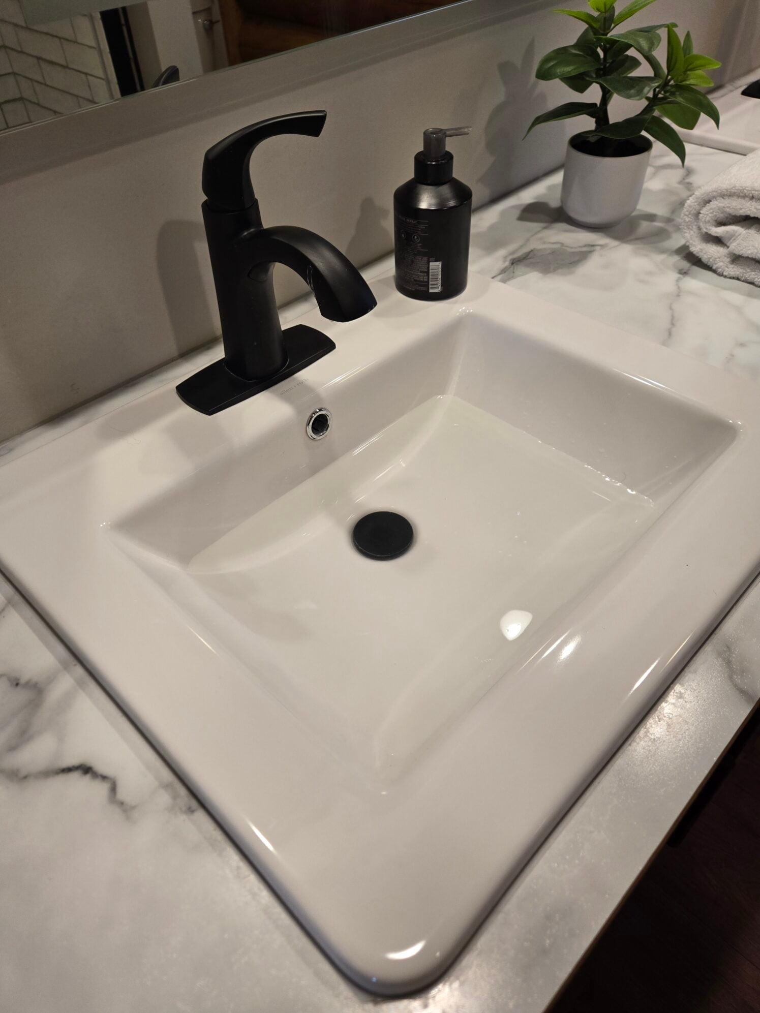 Bathroom vanity with new matte black faucet installation
