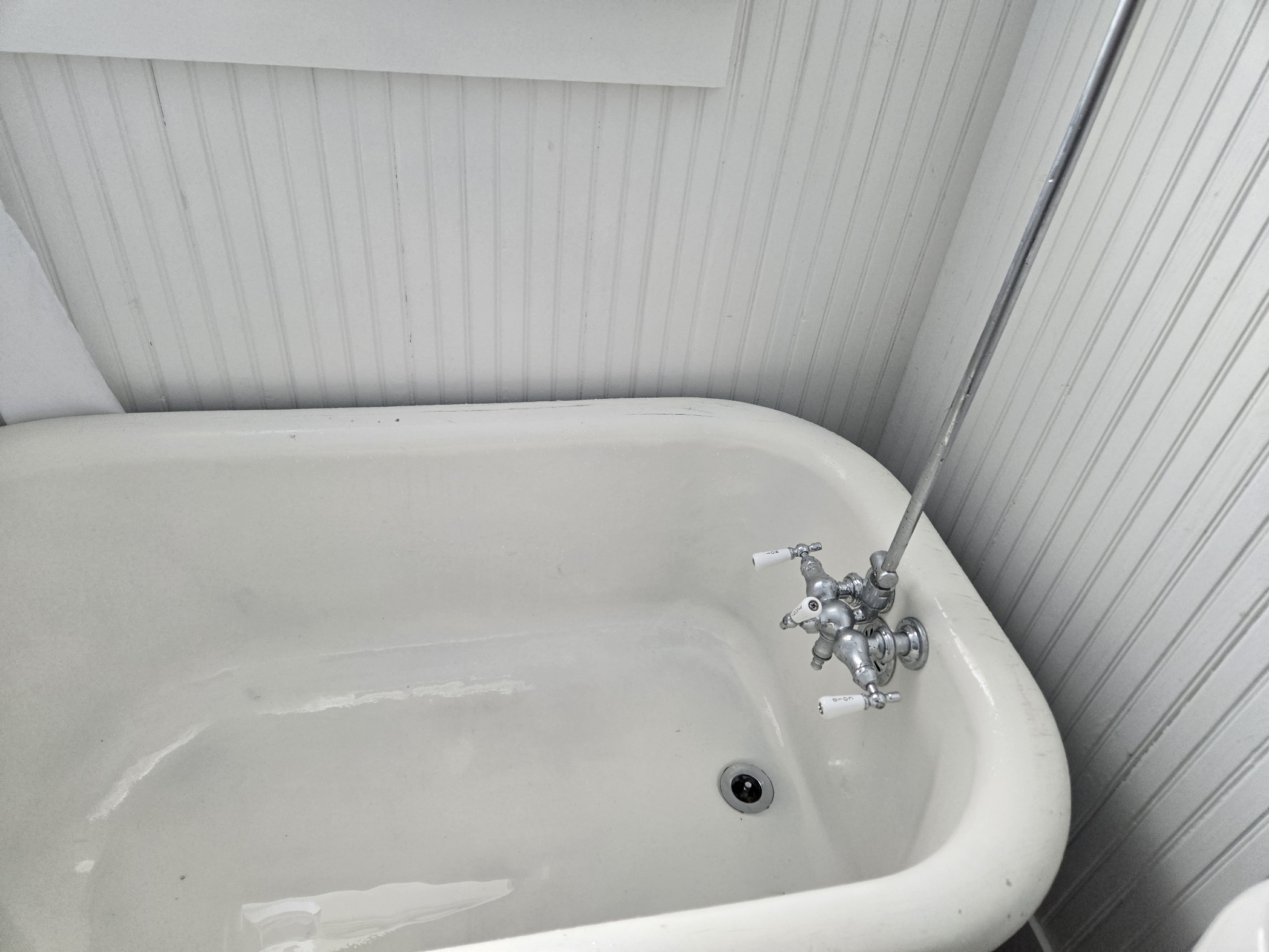 Restored clawfoot tub with exposed tub filler