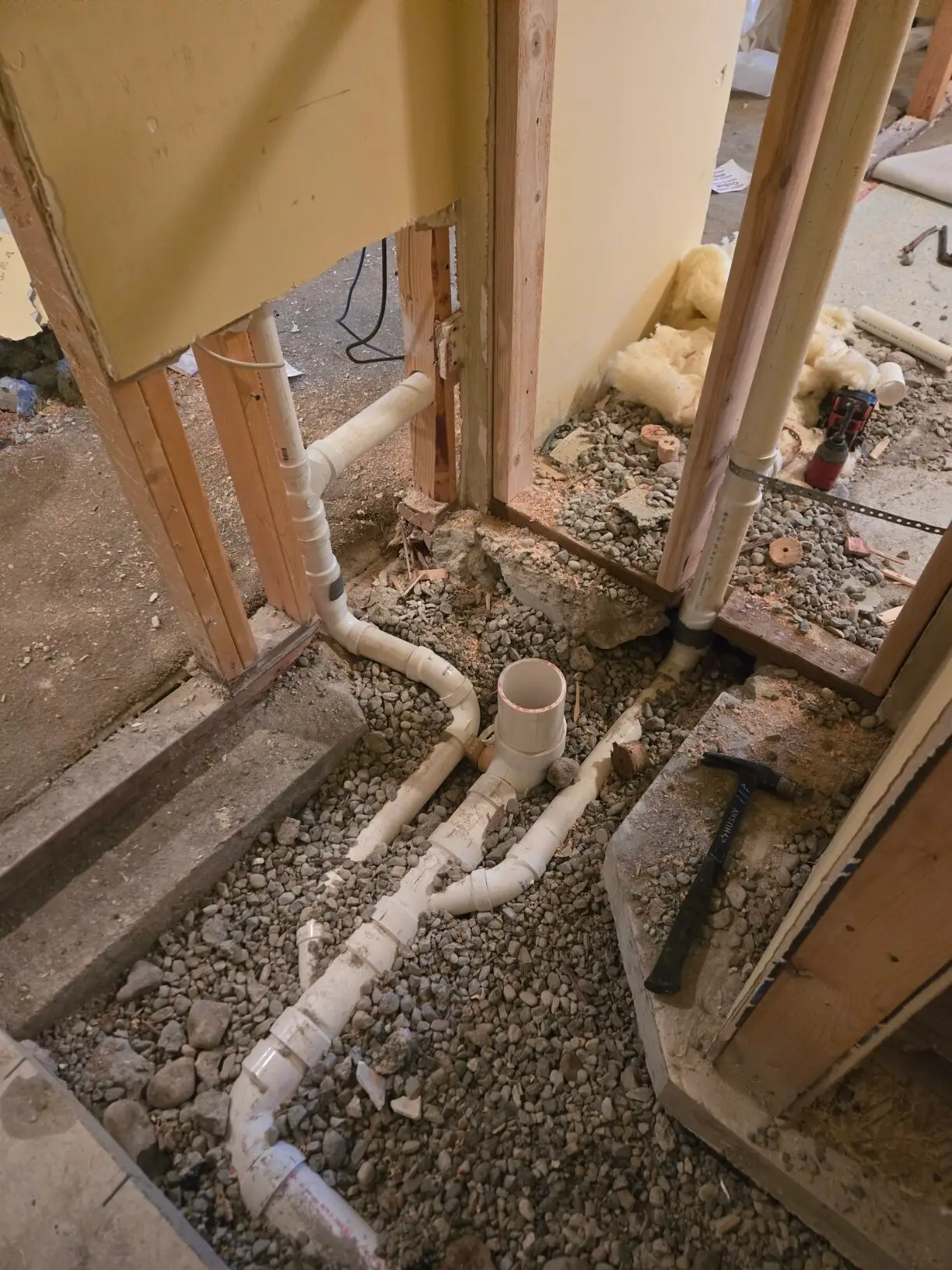 Underground PVC drain and sewer lines in a gravel trench