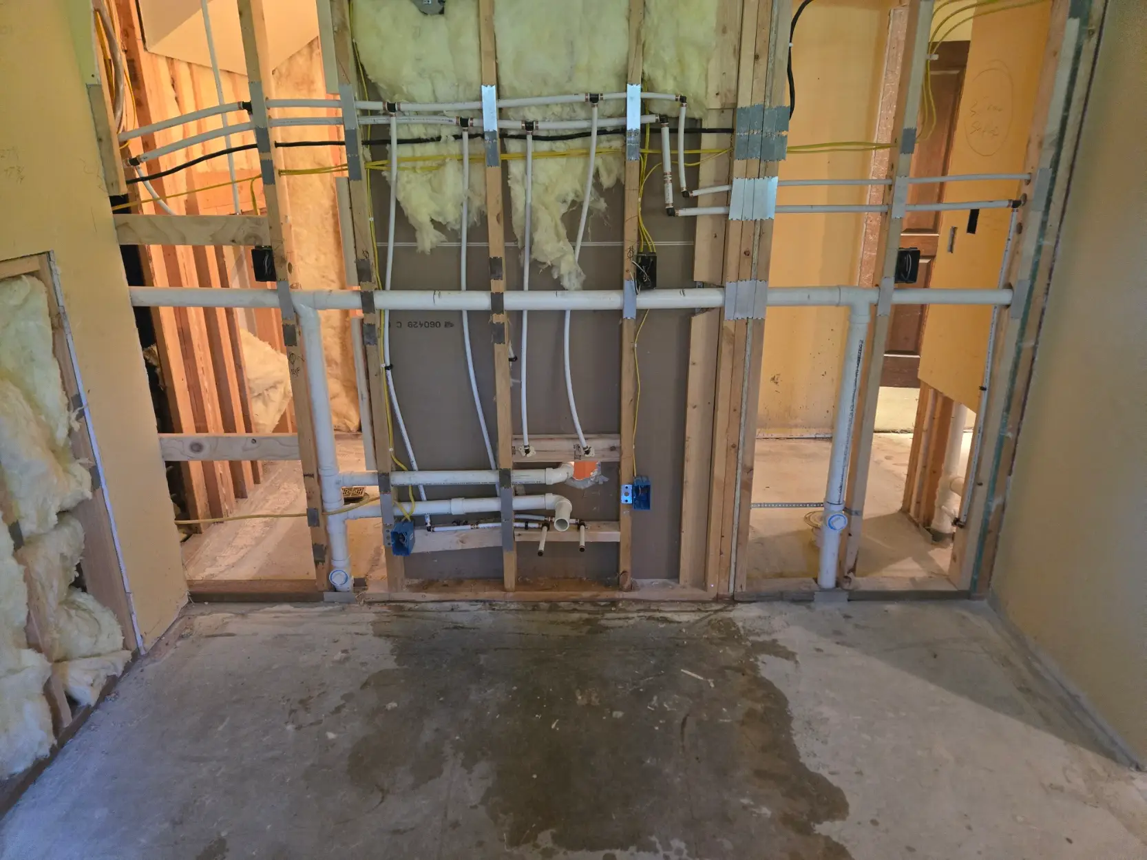 New plumbing rough-in inside framed bathroom walls