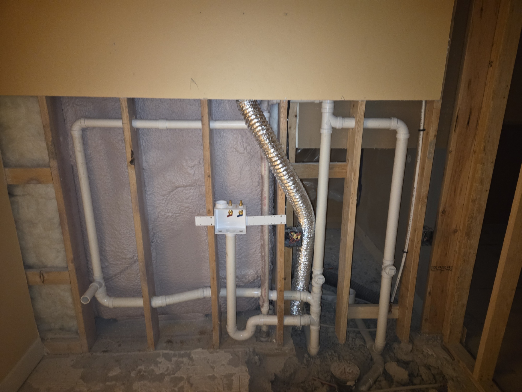 New construction plumbing rough-in with PVC drain lines