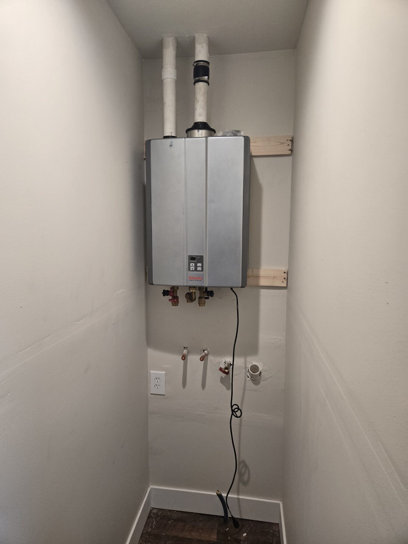 Tankless water heater installation in a utility closet