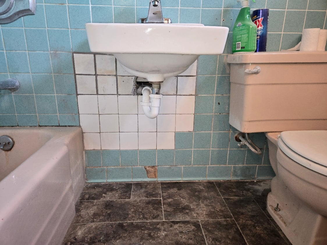 Bathroom sink drain and supply lines during a plumbing repair