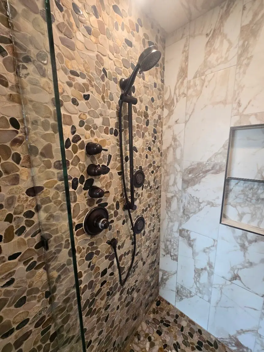 Custom tiled walk-in shower with handheld shower system installed by Lucas Plumbing